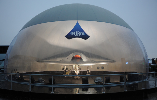 nEUROn UCAV, sheltered from the pouring rain in its styled protective bubble at the 50th Paris Air Show. Photo: Dassault