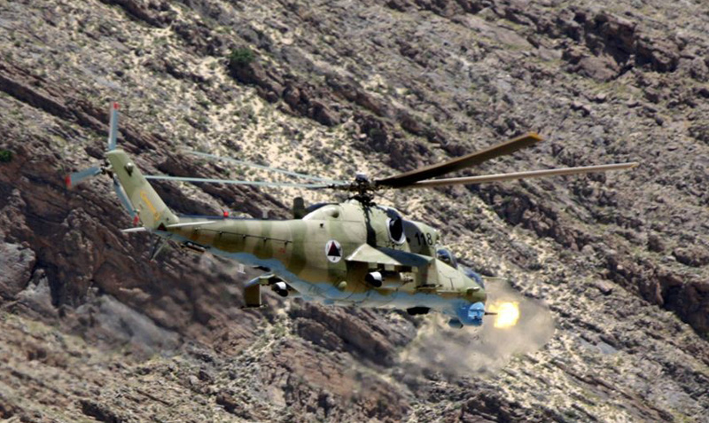 An Mi-35 attack helicopter fires during a gunnery training mission May 27, 2009 over the East River Range Complex near Bagram Air Base. This mission was the first time 57 mm rockets and the 12.7 mm cannon have been fired by the Afghan National Army Air Corps in more than eight years, and will eventually allow the Afghans to provide their own close air support. Photo:  Edward Gyokeres