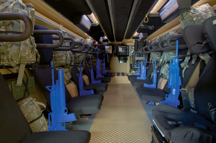 An look into the troop compartment shows the padded ceiling, canted corners, blast isolated 'floating floor' and individual seating, with head and foot rests, stowage for the personal gear and 'virtual windows' - vision blocks displaying a video image taken from 360 degree cameras located all around the vehicle.   