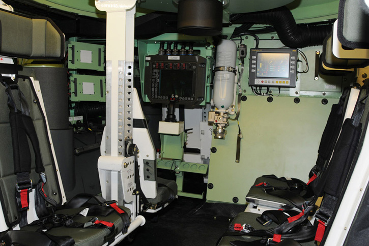 An internal view of the Piranha 5 showing two blast protecting passenger seats, the gunner station remotely operating the Protector overhead weapon station, and the driver station in the far-left side. Photo: GDELS 