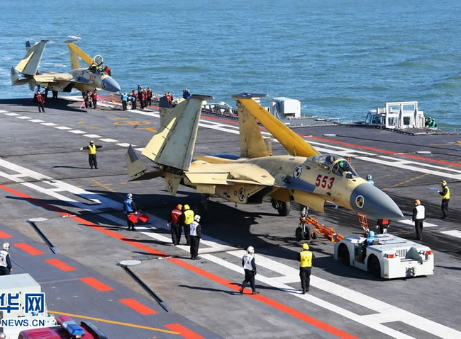A pair of J-15 jet fighters prepared for flight from the deck of the Chinese aircraft carrier Liaoning. Photo: Xinhua
