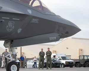 Maj. Gen. Jeff Lofgren (left), U.S. Air Force Warfare Center commander, and Brig. Gen. Charles Moore (right), 57th Wing commander, wait to greet the pilots of the two F-35 Lighting IIs that arrived at Nellis Air Force Base, Nev., March 6, 2013