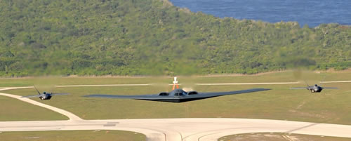 B2 Spirit escorted by two F-22A Raptors flying over Anderson AFB, Guam. US Air Force photo