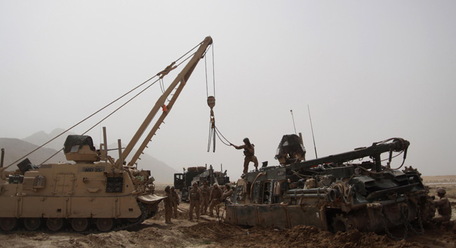 Marines with 1st Combat Engineer Battalion use an M88A2 Hercules to recover an M88A1 after getting stuck in a mud patch, March 16, 2011 