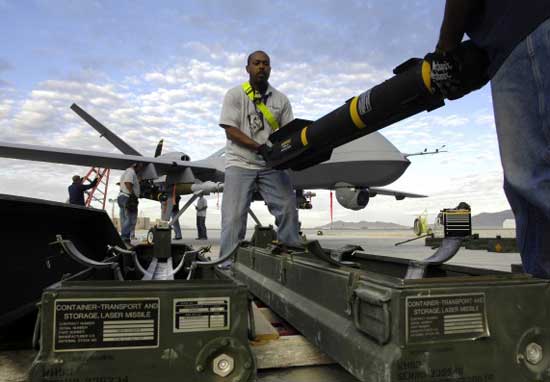 Laser guided bombs and hellfire missiles are loaded on a General Atomics MQ-9 Reaper drone prior to a mission in Afghanistan,