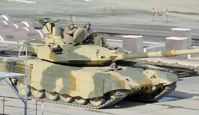 Deputy P.M. in charge of defense industry Dimitry Rogozin takes a ride on the T-90M at the demonstration and testing track at Niznhy Tagil.