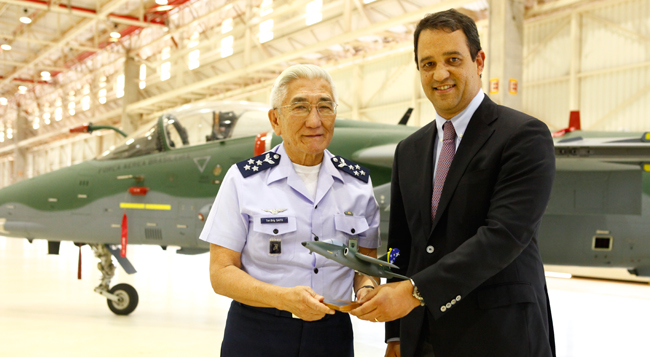 FAB (Brazilian Air Force ) Aeronautics Commander,  General Juniti saito receives the first A-1M modernized jet fighter form Luiz Carlos Aguiar, President of Embraer Defense & Security