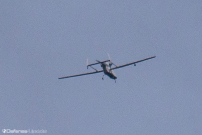 The 'Forpost' unmanned aerial vehicle, From Oboronprom, is actually an Israeli Searcher 2 UAV was seen on patrol during thdelivered by IAI under an arms transfer package with Russia in 2010. The drone, operated by Oboromprom in support of the Ministry of Defense, was following the firing display, assisting target acquisition and battle damage assessment. Imaging from UAS were displayed on the screens in front of the audience throughout the display. Photo: Noam. Eshel, Defense-Update