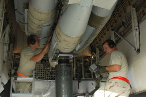 A Weapons Load Crew with the 379th Expeditionary Aircraft Maintenance Squadron at a Southwest Asia air base, loads two-thousand pound bombs onto a B-1B Lancer to prepare it for a mission December 21. Staff Sgt. Brandon Neitz (left) and Technical Sgt. James Sheldon (right) attach the bomb to the conventional rotary launcher inside the bomb bay of the aircraft. (United States Air Force photo by Staff Sergeant Douglas C. Olsen)