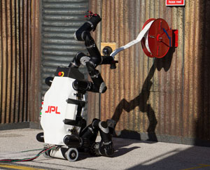 JPL's Robosimian manages the hose in one of DRC's task. Photo: DARPA 