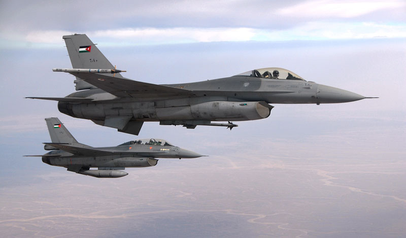 Two Royal Jordanian Air Force F-16s fly alongside a U.S. Air Force KC-135 Stratotanker aircraft while waiting to connect for fuel over Jordan. Photo: US Air Force