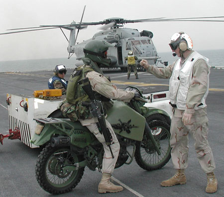 A member of the 15th Marine Expeditionary Unit (MEU) Special Operations Capable (SOC) waits his turn to onload his motorcycle for a helicopter flight into Kuwait. Photo: US Navy