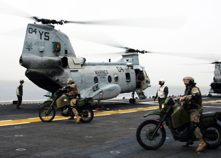 26th MEU scouts on board an LHD at the Mediterranean load two KLR-250D8 motorcycles onto a CH-46 helicopter. Photo: USMC