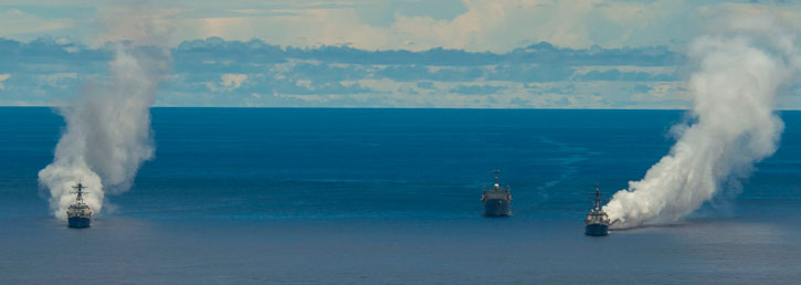 USS Mustin (DDG 89), USS Wayne E. Meyer (DDG 108) and USS Frank Cable (AS 40) test maritime obscurants held south of Guam to assess their tactical effectiveness for anti-ship missile defense. The systems and tactics were tested under a variety of at-sea conditions using Seventh Fleet units and assets from the U.S. Army, Navy, and Air Force to evaluate how radar-absorbing, carbon-fiber clouds can prevent a missile from detecting and striking its target as part of a layered defense. (U.S. Navy photo by Mass Communication Specialist 2nd Class Timothy Wilson)