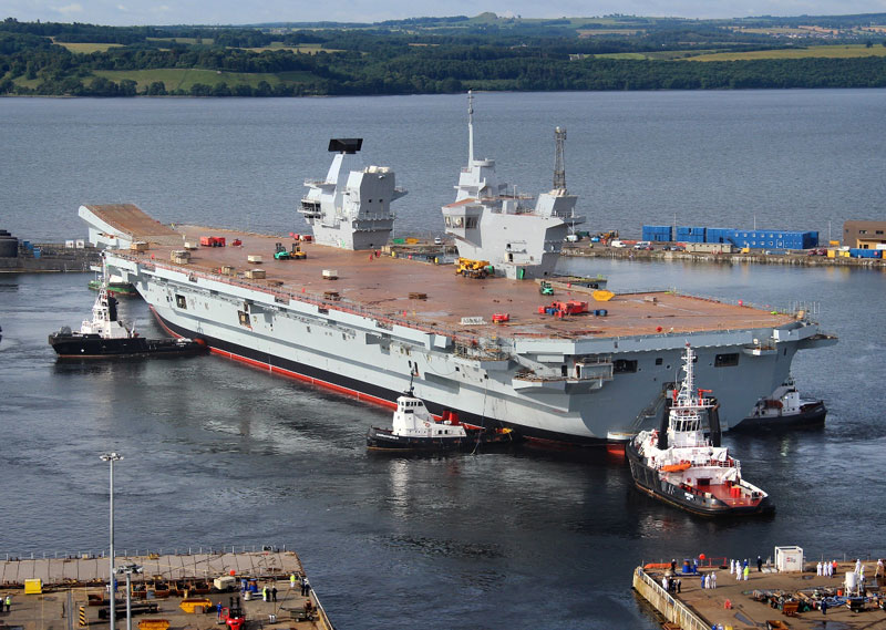 It then took only three hours this morning to carefully manoeuvre HMS QUEEN ELIZABETH out of the dock with just two metres clearance at either side and then berth her alongside a nearby jetty. Photo: UK MOD, Crown Copyright