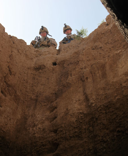 US soldiers inspect a water well, connected to an underground tunnel system, used to store rainwater in the afghan winter. In the dry season, these systems are often used to store  caches of weapons and improvised explosive device. Photo: US Marine Corps, by Sgt. James Mercure. 