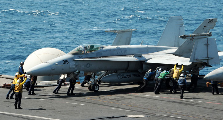 An F/A-18E from the VFA-15 "Valions", CVN 77 George H.W. Bush prepared for takeoff on a strike mission in Iraq, August 8, 2014. The aircraft were carrying an AG/M-54 Laser JDAM laser/GPS guided bombs and Maverick guided missile. Photo: US Navy by M. Keith
