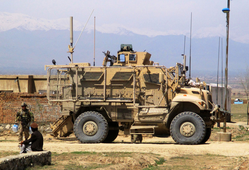 A MaxxPro MRAP sets up a secure position, allowing Soldiers from White Platoon, Apache Troop to dismount and conduct nearby street-level engagements with local villagers April 4, 2014. photo: U.S. Army by Joseph Krebsbach