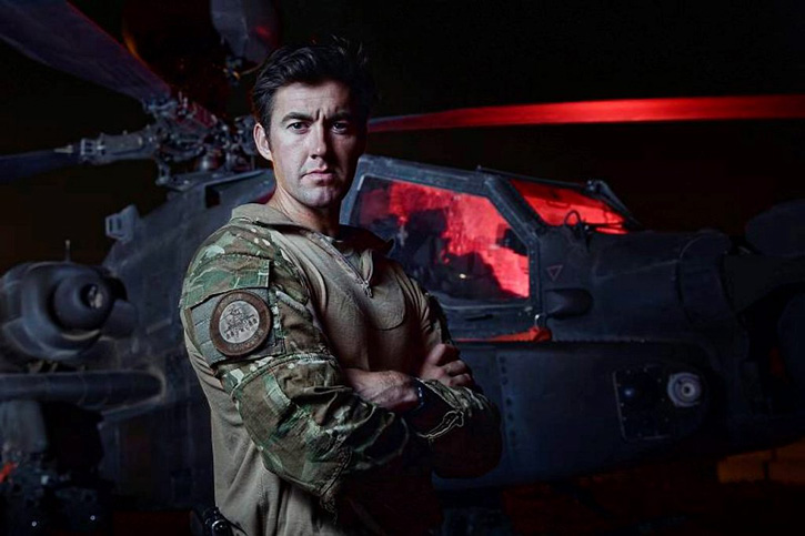 Portrait of an Apache pilot, standing in front of his Apache attack helicopter, prior to a mission in Helmand, Afghanistan in 2013. Photo: MOD, Crown Copyright by Corp. Si Longworth.