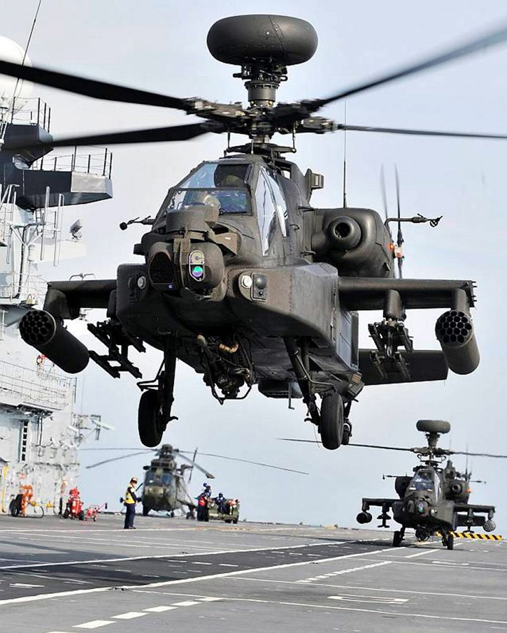 Two Apache helicopters from 664 Squadron, Army Air Corps, perform landing practice onboard HMS Illustrious. Photo: MOD, Crown Copyright, by Dean Nixon .